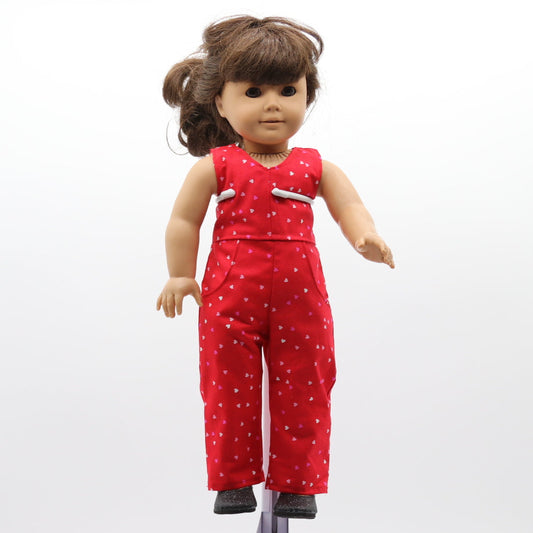 Doll wearing a red outfit with white polka dots on a white background